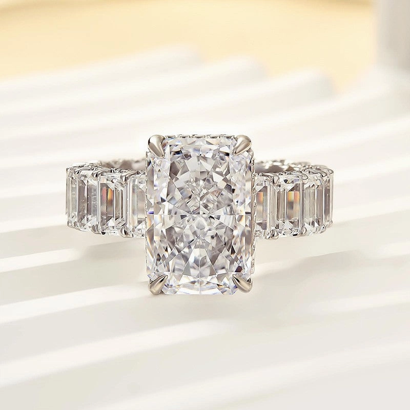 Luxurious 5.0 Carat Radiant Cut Engagement Ring With Emerald Cut Band Flat Lay Unique Treasures