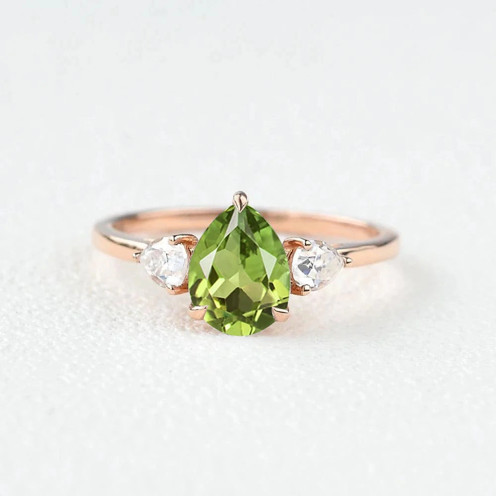 Graceful Motion Holiday Style Pear Shaped Peridot Three Stones Ring