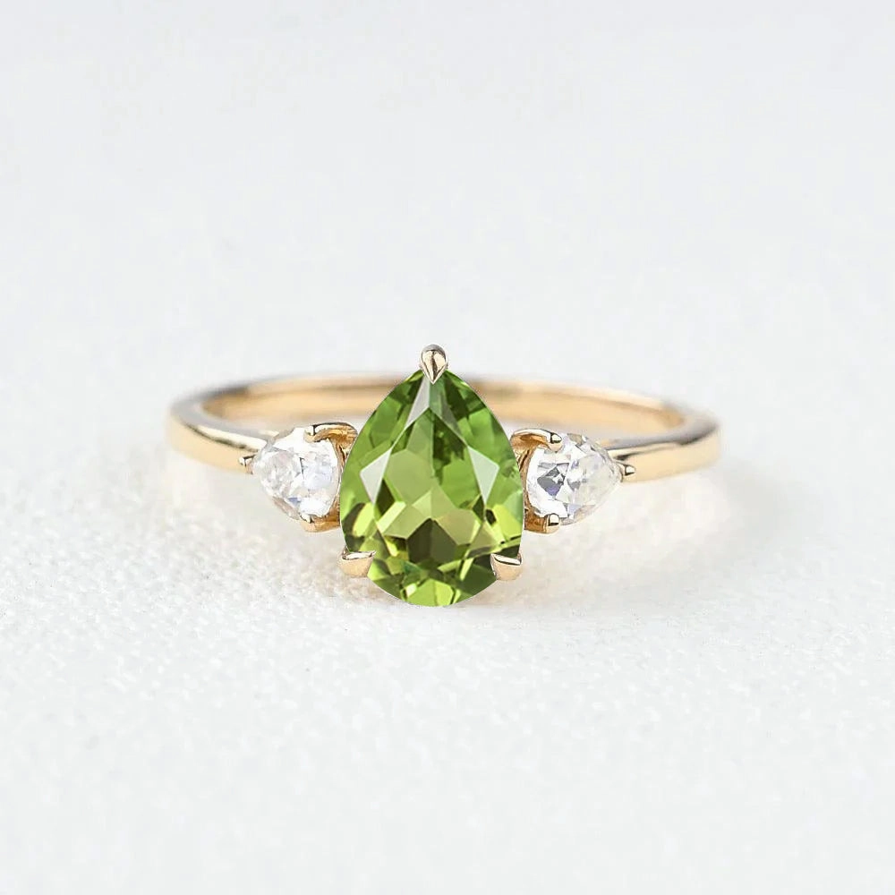 Precious Treasures Pear Shaped Peridot Three Stones Ring